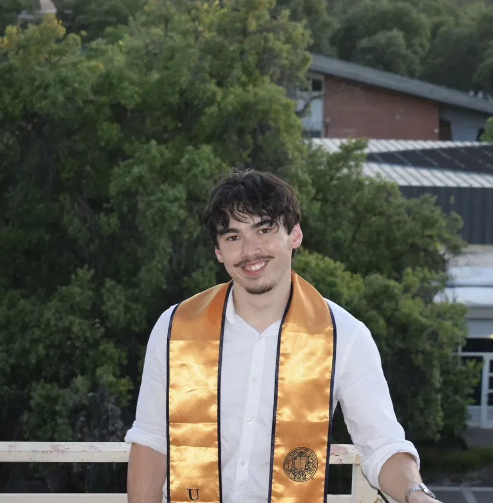 Jayden Betts at his UC Davis graduation in a gold honor stole
